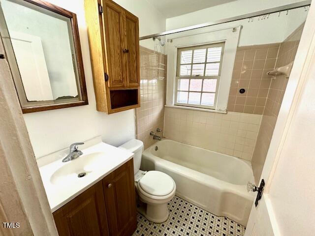 3810 Pendergrass St, Durham, NC 27704 - bathroom with vanity, toilet, shower / washtub combination, and tile patterned flooring