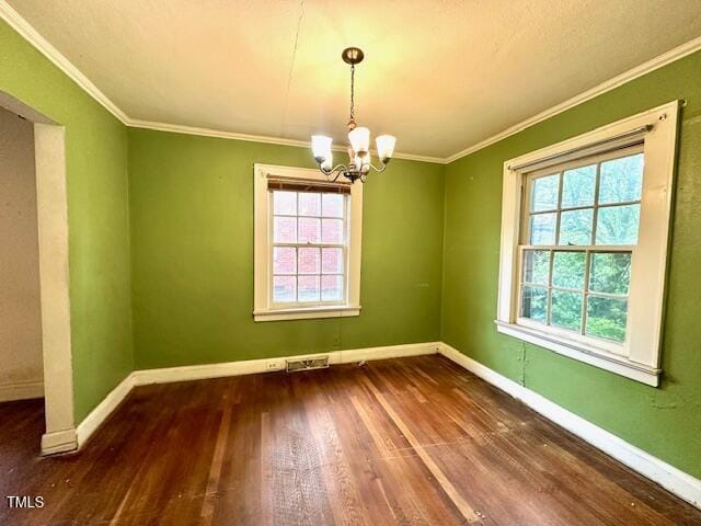 3810 Pendergrass St, Durham, NC 27704 - spare room with a chandelier, baseboards, wood finished floors, and crown molding