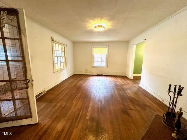 3810 Pendergrass St, Durham, NC 27704 - spare room with wood finished floors, baseboards, and ornamental molding