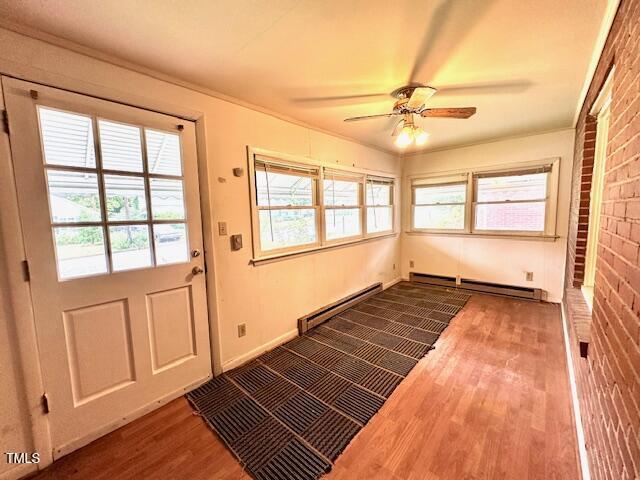 3810 Pendergrass St, Durham, NC 27704 - entryway featuring baseboard heating, wood finished floors, a ceiling fan, and healthy amount of natural light