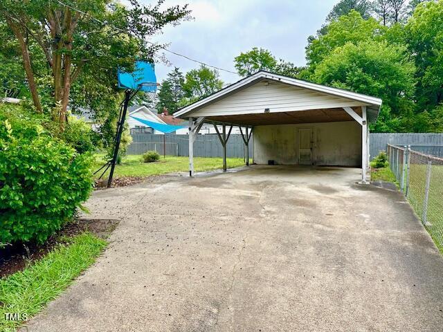 3810 Pendergrass St, Durham, NC 27704 - view of car parking featuring asphalt driveway and a carport