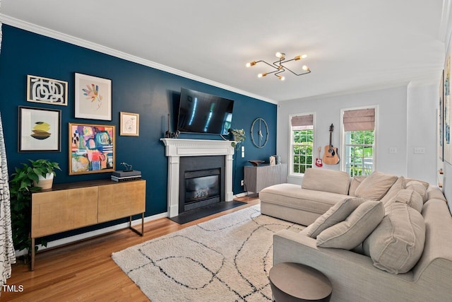 5 Providence Ridge Ln, Durham, NC 27713 - living room featuring wood finished floors, a chandelier, ornamental molding, and a fireplace with flush hearth