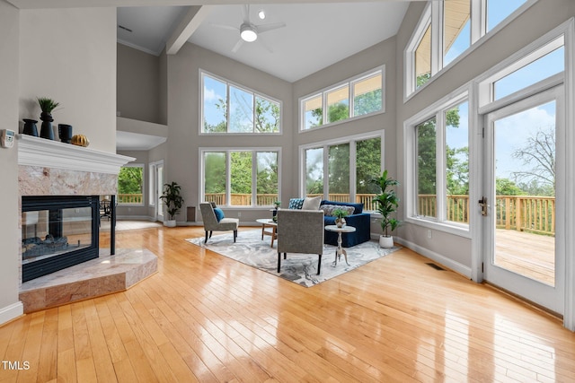 7918 Dairy Ridge Rd, Mebane, NC 27302 - living room featuring a ceiling fan, wood-type flooring, baseboards, a towering ceiling, and a premium fireplace