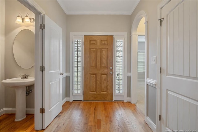 45 Remington Hills Dr, Bunnlevel, NC 28323 - foyer with baseboards, light wood-style floors, ornamental molding, and arched walkways