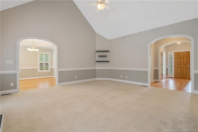 45 Remington Hills Dr, Bunnlevel, NC 28323 - unfurnished room featuring arched walkways, carpet flooring, high vaulted ceiling, ceiling fan, and a chandelier