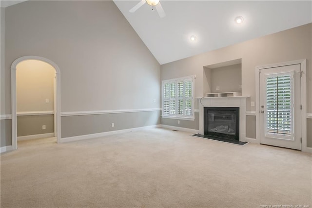 45 Remington Hills Dr, Bunnlevel, NC 28323 - unfurnished living room featuring high vaulted ceiling, carpet flooring, a ceiling fan, a fireplace with flush hearth, and baseboards