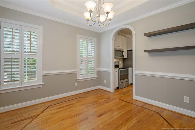 45 Remington Hills Dr, Bunnlevel, NC 28323 - unfurnished dining area with light wood-type flooring, a chandelier, baseboards, arched walkways, and ornamental molding