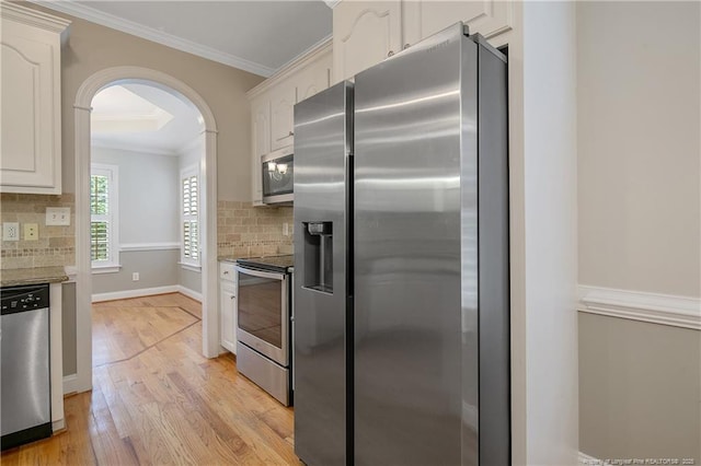 45 Remington Hills Dr, Bunnlevel, NC 28323 - kitchen with stainless steel appliances, white cabinets, backsplash, and ornamental molding