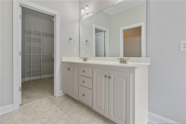 45 Remington Hills Dr, Bunnlevel, NC 28323 - full bathroom with double vanity, baseboards, tile patterned flooring, and a walk in closet