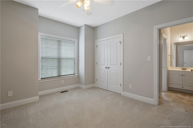 45 Remington Hills Dr, Bunnlevel, NC 28323 - unfurnished bedroom with carpet, baseboards, a closet, and a sink