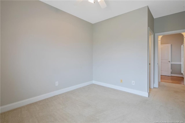 45 Remington Hills Dr, Bunnlevel, NC 28323 - empty room with light colored carpet, ceiling fan, baseboards, and arched walkways
