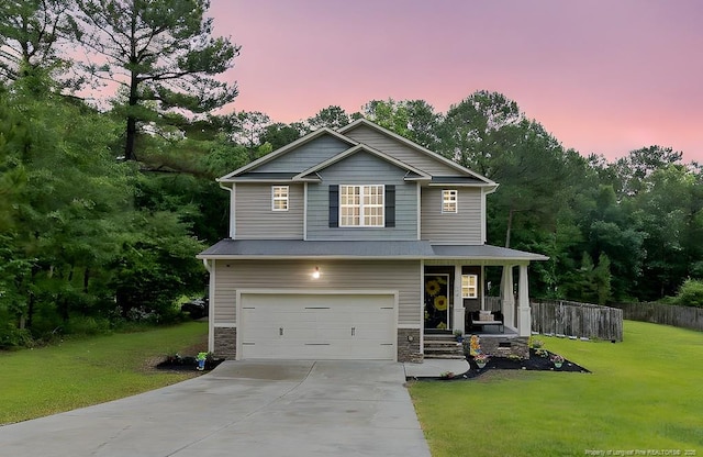 265 Tactical Dr, Bunnlevel, NC 28323 - view of front facade with a porch, an attached garage, concrete driveway, and stone siding
