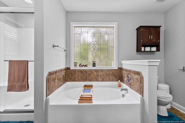 265 Tactical Dr, Bunnlevel, NC 28323 - bathroom featuring toilet, a garden tub, and a shower stall
