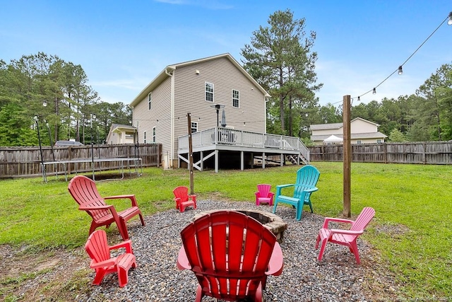 265 Tactical Dr, Bunnlevel, NC 28323 - view of yard featuring an outdoor fire pit, a trampoline, and a wooden deck