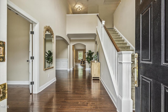 347 Country Mill Way, Fuquay Varina, NC 27526 - foyer featuring hardwood / wood-style floors, arched walkways, a towering ceiling, ornamental molding, and stairway