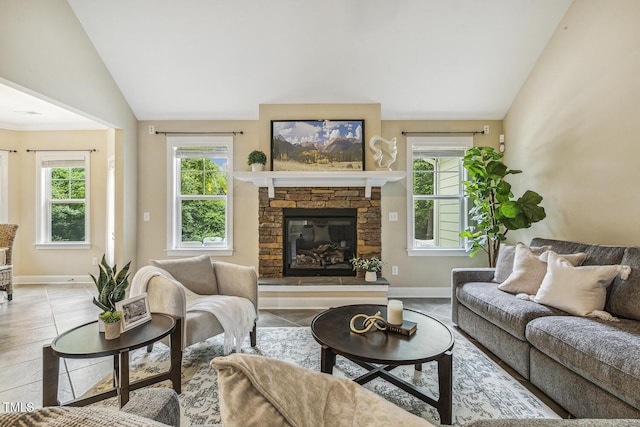 347 Country Mill Way, Fuquay Varina, NC 27526 - tiled living room featuring vaulted ceiling, healthy amount of natural light, baseboards, and a fireplace
