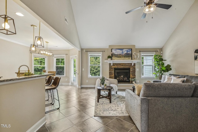 347 Country Mill Way, Fuquay Varina, NC 27526 - living area featuring baseboards, ceiling fan, a fireplace, lofted ceiling, and dark tile patterned floors