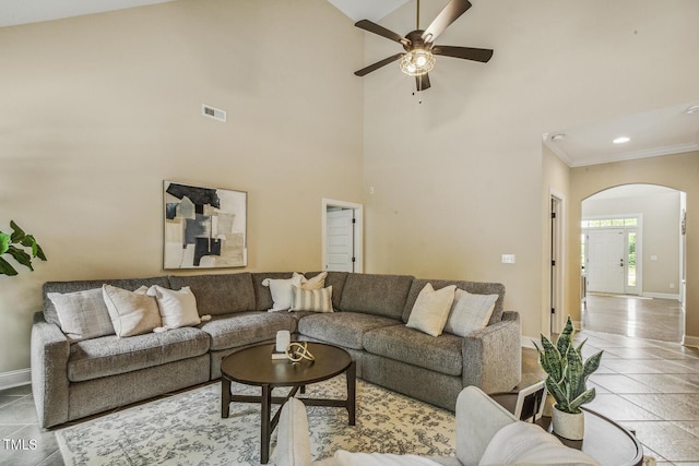 347 Country Mill Way, Fuquay Varina, NC 27526 - living area with arched walkways, baseboards, ceiling fan, ornamental molding, and a towering ceiling