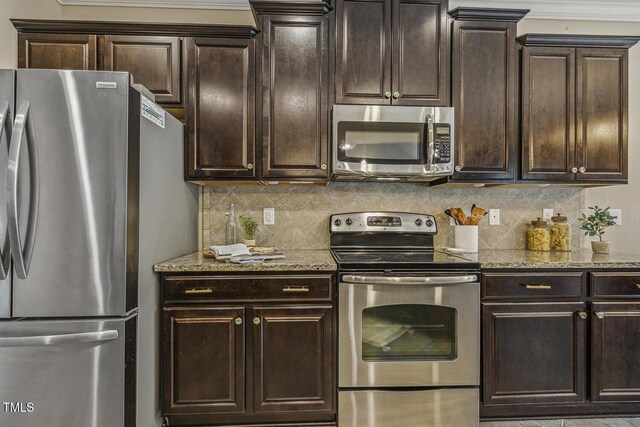 347 Country Mill Way, Fuquay Varina, NC 27526 - kitchen featuring stainless steel appliances, tasteful backsplash, light stone counters, and dark brown cabinetry