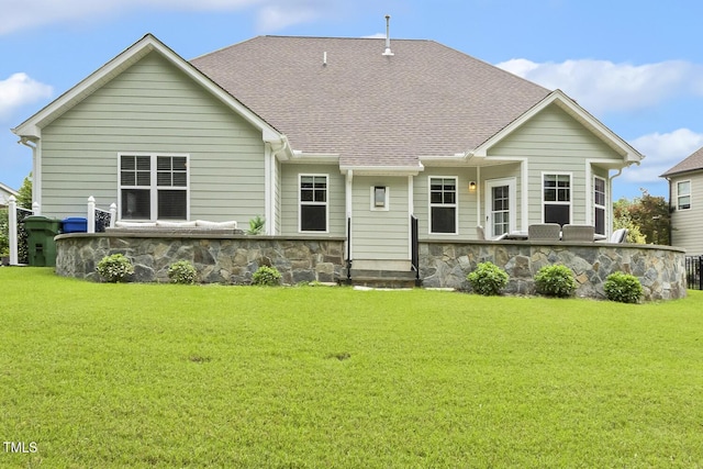 347 Country Mill Way, Fuquay Varina, NC 27526 - rear view of property featuring stone siding, a lawn, and roof with shingles