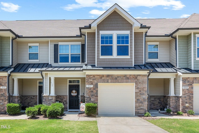 7807 Elmshire Way, Raleigh, NC 27616 - view of front of home with a standing seam roof, an attached garage, driveway, and covered porch