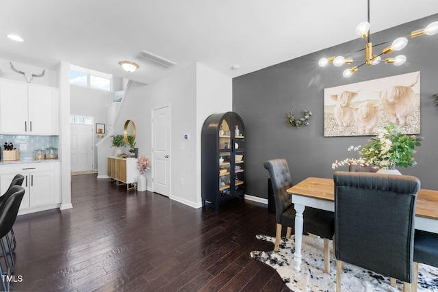 7807 Elmshire Way, Raleigh, NC 27616 - dining area with dark wood-style floors, baseboards, and a chandelier