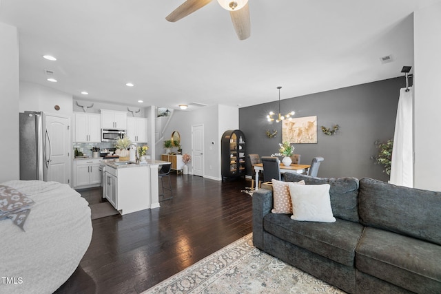 7807 Elmshire Way, Raleigh, NC 27616 - living room featuring dark wood finished floors, recessed lighting, a ceiling fan, a chandelier, and baseboards