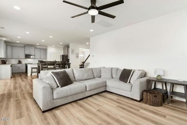 116 Hayfield Dr, Lillington, NC 27546 - living room with light wood-style flooring, a ceiling fan, recessed lighting, and stairs