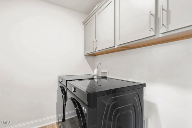 116 Hayfield Dr, Lillington, NC 27546 - laundry room featuring cabinet space, washer and clothes dryer, baseboards, and wood finished floors