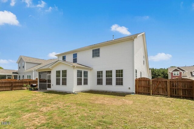 116 Hayfield Dr, Lillington, NC 27546 - back of property featuring a gate and a sunroom