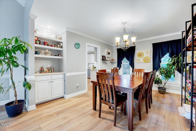 113 Fetzer Ct, Cary, NC 27513 - dining area featuring a chandelier, light wood-style flooring, crown molding, baseboards, and built in features