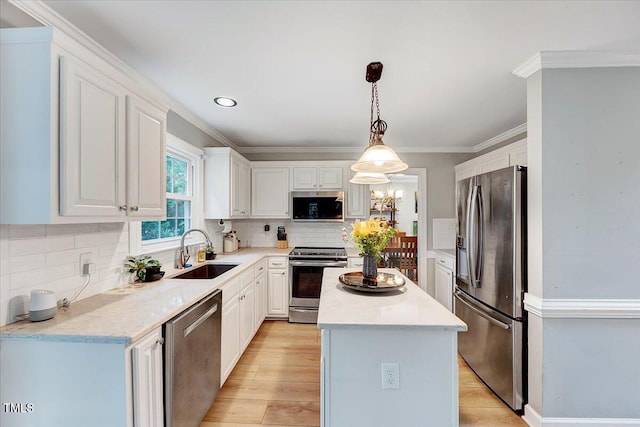 113 Fetzer Ct, Cary, NC 27513 - kitchen with appliances with stainless steel finishes, a sink, a kitchen island, white cabinets, and tasteful backsplash