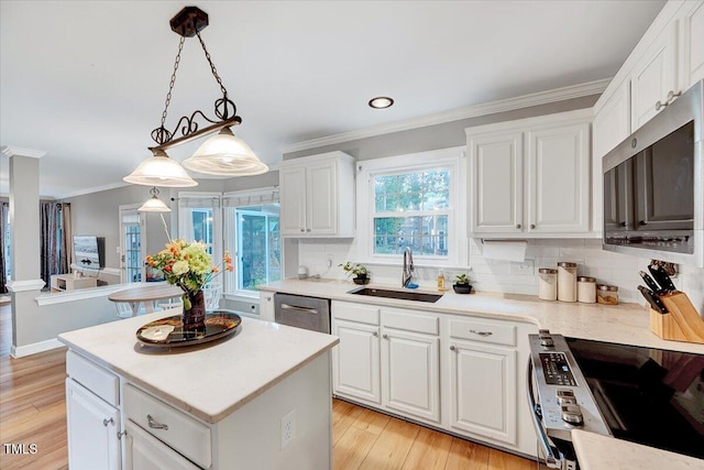113 Fetzer Ct, Cary, NC 27513 - kitchen with a sink, appliances with stainless steel finishes, decorative backsplash, ornamental molding, and white cabinets