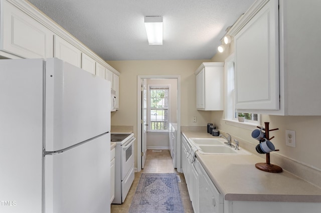 118 Setter Pt, Clayton, NC 27520 - kitchen with white appliances, a sink, white cabinets, baseboards, and a textured ceiling