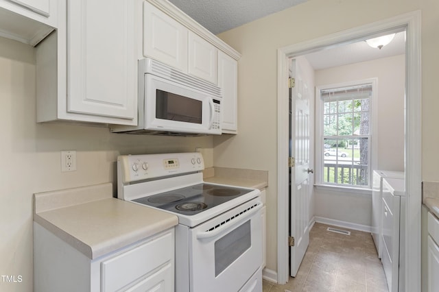 118 Setter Pt, Clayton, NC 27520 - kitchen featuring white appliances, white cabinets, light countertops, and baseboards