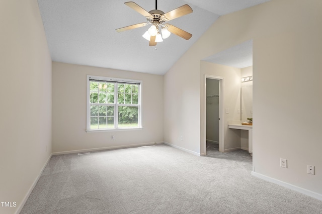 118 Setter Pt, Clayton, NC 27520 - unfurnished bedroom with carpet flooring, a walk in closet, vaulted ceiling, and baseboards