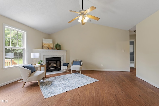 118 Setter Pt, Clayton, NC 27520 - living area with wood finished floors, baseboards, a high end fireplace, ceiling fan, and vaulted ceiling