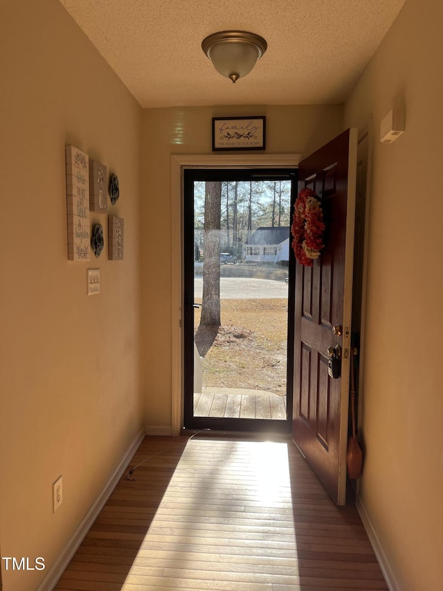 118 Setter Pt, Clayton, NC 27520 - doorway to outside with wood finished floors, a textured ceiling, and baseboards