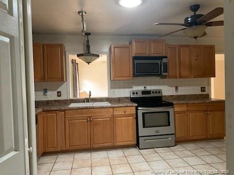 1813 Ashton Rd, Fayetteville, NC 28304 - kitchen featuring stainless steel appliances, a sink, ceiling fan, dark countertops, and crown molding