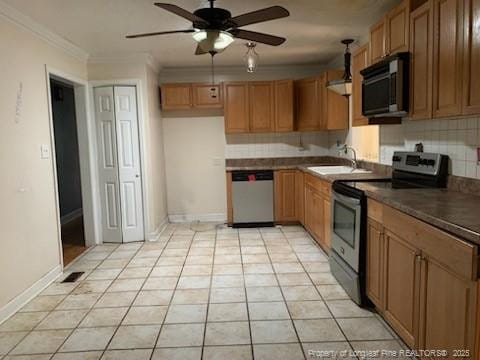 1813 Ashton Rd, Fayetteville, NC 28304 - kitchen with stainless steel appliances, a sink, tasteful backsplash, a ceiling fan, and crown molding