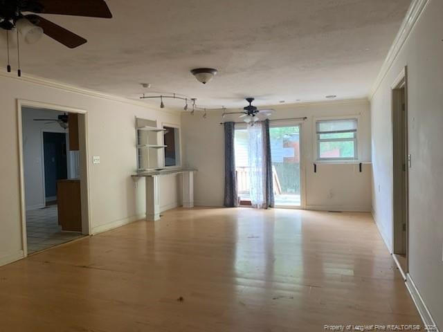 1813 Ashton Rd, Fayetteville, NC 28304 - unfurnished living room featuring a ceiling fan, crown molding, wood finished floors, and baseboards