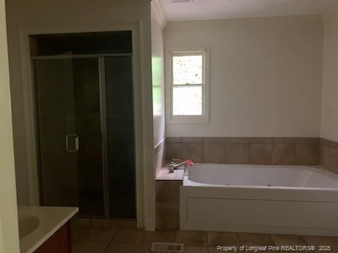 1813 Ashton Rd, Fayetteville, NC 28304 - bathroom with tile patterned floors, vanity, a garden tub, and a shower stall