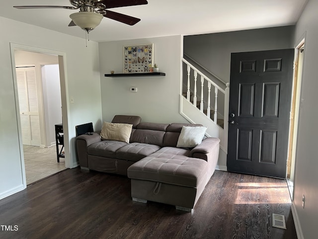 503 Pine Run, Knightdale, NC 27545 - living room featuring a ceiling fan, wood finished floors, stairway, and baseboards