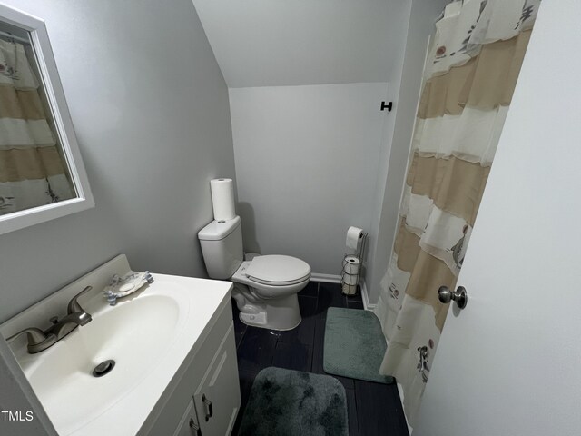 503 Pine Run, Knightdale, NC 27545 - bathroom featuring vanity, toilet, curtained shower, lofted ceiling, and tile patterned flooring