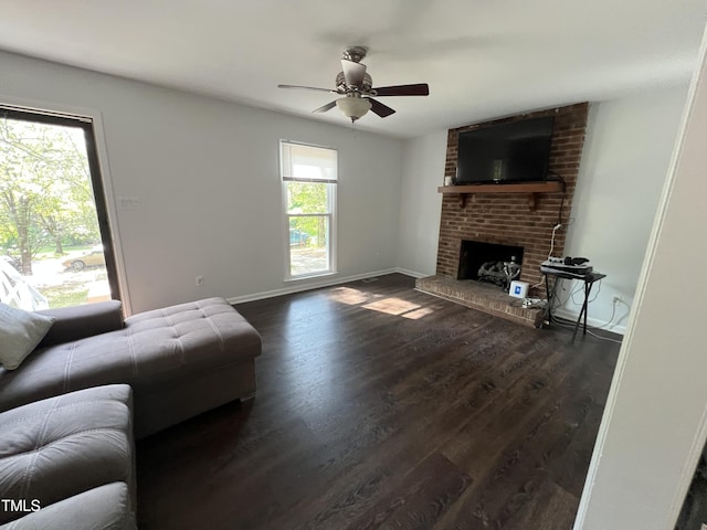 503 Pine Run, Knightdale, NC 27545 - living room with a ceiling fan, dark wood-style floors, a brick fireplace, and baseboards