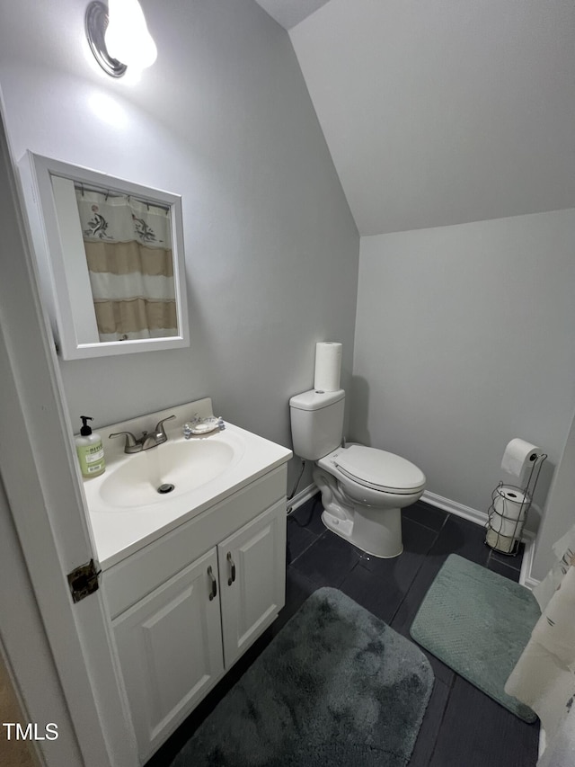 503 Pine Run, Knightdale, NC 27545 - bathroom with vaulted ceiling, vanity, toilet, tile patterned floors, and a shower with shower curtain
