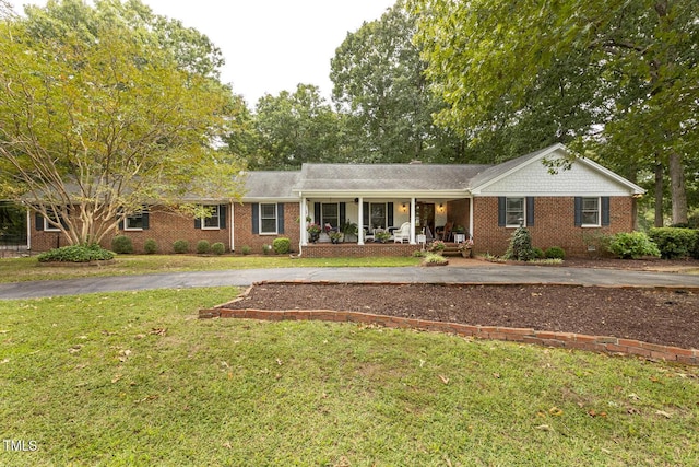 6517 Whitted Rd, Fuquay Varina, NC 27526 - ranch-style house with a porch, a front yard, driveway, and brick siding