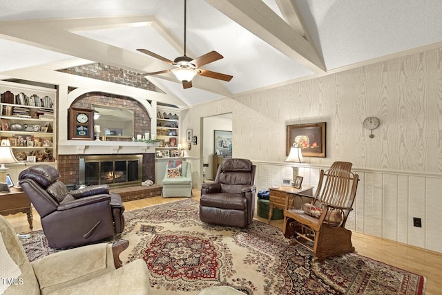 6517 Whitted Rd, Fuquay Varina, NC 27526 - living room with wood finished floors, a ceiling fan, built in shelves, a brick fireplace, and wood walls