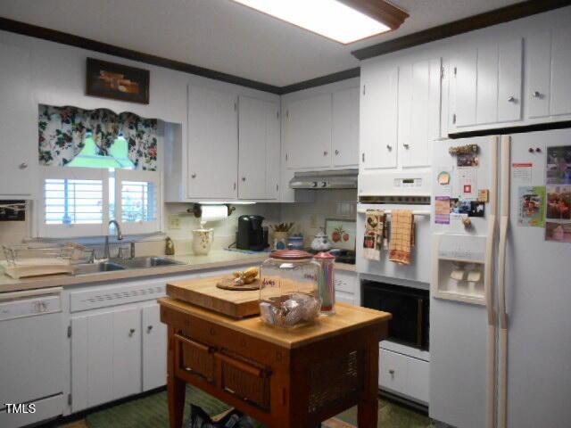 6517 Whitted Rd, Fuquay Varina, NC 27526 - kitchen featuring white appliances, light countertops, a sink, under cabinet range hood, and white cabinets