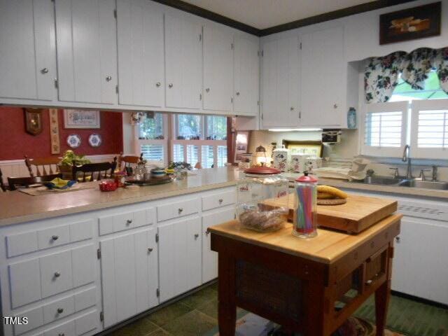 6517 Whitted Rd, Fuquay Varina, NC 27526 - kitchen featuring light countertops, white cabinets, and a sink